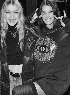 two young women posing for the camera with their fingers in the shape of an eye