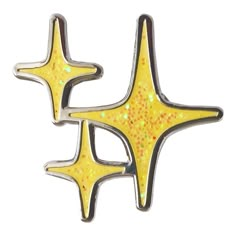 two yellow and black star shaped brooches with glitter on them, one is gold