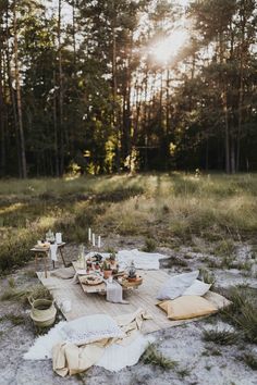 a picnic is set up in the middle of a field with food and drinks on it