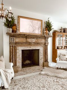 a living room filled with furniture and a fire place covered in blankets on top of a rug