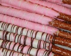 there are many pink and white candy canes lined up