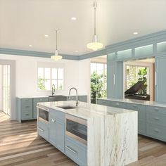 a large kitchen with marble counter tops and blue cabinets, along with hardwood flooring