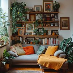 a living room filled with lots of plants and bookshelves on top of shelves