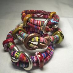 Serape Cord Hook Bracelet.  Designed to look tribal, these bracelets brings to mind Mexican Blankets and ponchos. The colorful fabric calls out of happiness and celebration!  Silver and Brass 5mm hook clasp and ceramic spacer beads.  I LOVE serapes!  The Green One Is 9 Inches.  The Maroon One Is 8 1/2 Inches.  The Pink One Is 9 Inches  If you need a different size send me a message and I will see what I can do. Adjustable Multicolor Artisan Wrap Bracelet, Artisan Beaded Multicolor Wrap Bracelet, Festival Artisan Wrap Bracelet With Colorful Beads, Artisan Multicolor Beaded Wrap Bracelet, Red Adjustable Bohemian Wrap Bracelet, Artisan Multicolor Wrap Bracelet For Festival, Multicolor Bohemian Braided Bracelets For Festivals, Hippie Multicolor Beaded Wrap Bracelet, Bohemian Braided Bracelets For Festivals