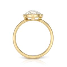 a yellow gold ring with a white diamond in the center and a single stone on top