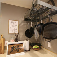 pots and pans are hanging on the rack