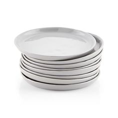 stack of white plates stacked on top of each other in front of a white background