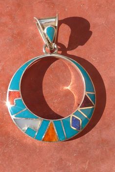 This beautiful Black Inca Calendar jewelry set is made by hand by the beautiful Quechua people of the Peruvian Andes. It is handmade in 950 silver, Lapiz Lazuli Stone and Turquoise Stone by a local family of jewelry artesians. Best quality artisan work PENDANT : Weight : 6.1 gr Diameter : 3.1 cm Height with the hook :4.5 cm EARRINGS: Weight: 11 gr Diameter : 3.1 cm Height with the hook : 5.3 cm Southwestern Sterling Silver Round Pendant Jewelry, Southwestern Sterling Silver Jewelry With Round Pendant, Multicolor Natural Stones Round Pendant Jewelry, Blue Necklace With Round Inlay, Southwestern Style Hallmarked Round Jewelry, Artisan Multicolor Pendant Jewelry, Turquoise Inlay Sterling Silver Jewelry, Sterling Silver Turquoise Inlay Jewelry, Sterling Silver Round Pendant For Festivals