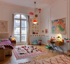 a child's bedroom with lots of toys on the floor