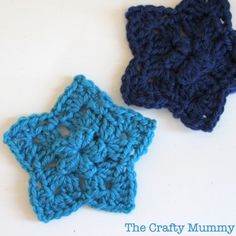 two crocheted stars sitting next to each other