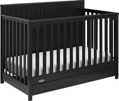 a black crib with white sheets on the bottom and side rails, in front of a white background