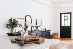 a kitchen island with flowers in a vase on it