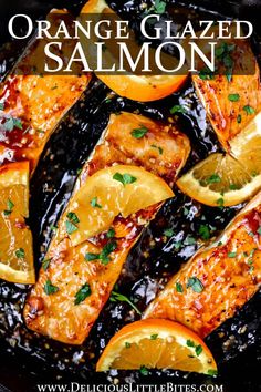 orange glazed salmon in a skillet with lemons and parsley