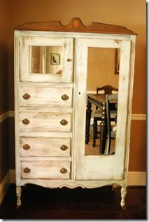 an old white dresser with drawers and mirror