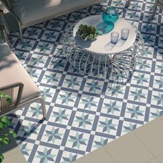 a living room with blue and white tiles on the floor next to a couch, chair and coffee table