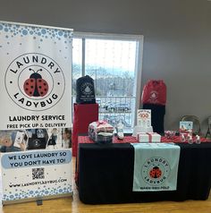 a ladybug laundry service booth set up on a hard wood floor