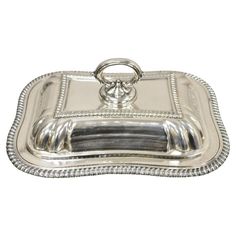 a silver tray with beaded edges and handles