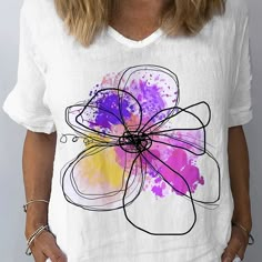 a woman wearing a t - shirt with a flower on it