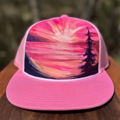 Looking for a way to stand out from the crowd? Check out Mary Bea Art's unique hand-painted hats! Each hat is a one-of-a-kind piece of wearable art, individually painted by Petoskey artist Mary Bea McWatters. With their bold colors and eye-catching designs, these hats are the perfect way to express your individual style and show off your love of nature and art. Whether you're looking for a way to add a pop of color to your outfit or just want a unique accessory that's sure to turn heads, Mary Bea Art's hand-painted hats are the perfect choice. Don't settle for ordinary - choose something truly special with a hand-painted hat! Adjustable Pink 5-panel Hat, Pink Adjustable 5-panel Hat, Pink Trucker Hat With Curved Brim For Festivals, Artistic Adjustable Trucker Hat, Artistic Hand Painted Flat Brim Hat, Artistic Hand Painted Adjustable Hats, Artistic Hand Painted Cap, Artistic Hand-painted Cap, Pink Handmade Cap