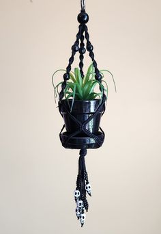 ☠🖤Gothic Skulls Black Beaded Macrame Plant Hanger Terra-Cotta Clay Pot and White Skull Beads☠🖤 📏Choose your Pot Size 2 inch, 2.5 inch, 3 inch, 4 inch, or 6 inch🪴 🖐All Planet Hangers are handmade by me using sustainable and durable Hemp cord, black 💀Wooden black beads, white acrylic skull beads, and black glass seed beads throughout 🎨Terra-cotta pot w/ drainage hole, hand-painted black with high-quality acrylic paint and waterproof top coat sealer 🪴Silver Metal O Ring is made of heavy-duty nickel-plated alloy metal, durable, and rust-resistant. Hangs on any hook in your home🏠 🪐🎁Planet Hangers are the perfect gift for any plant lover ✴️Plant not included 👉Check out more plant hangers at my shop here: PlanetHanger.etsy.com Beaded Macrame Plant Hanger, Black Plant, Terra Cotta Clay Pots, Beaded Macrame, Black Macrame, Skull Beads, Skull Gifts, Hemp Cord, Drip Tray