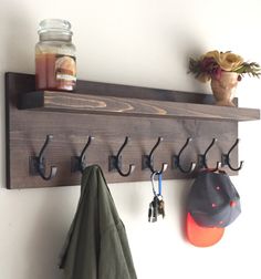 there is a coat rack with hooks on it and hats hanging from the hooks