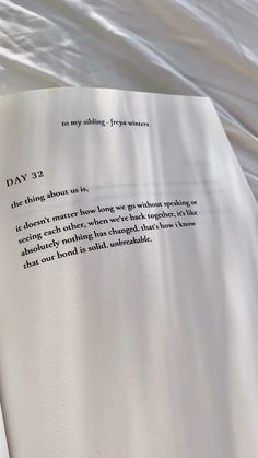 an open book laying on top of a bed covered in white sheets with the words day 22 printed on it