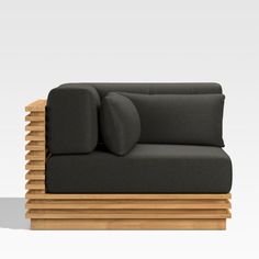 a black couch with pillows on top of it