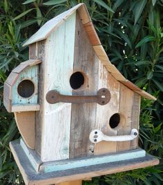 a bird house made out of wooden boards