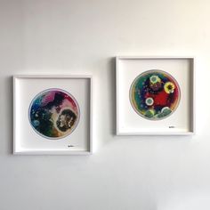 two framed art pieces hanging on the wall