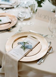 the table is set with place settings and silverware