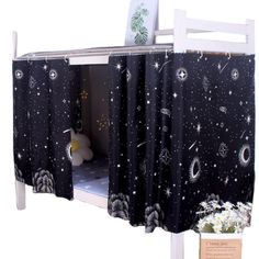 a bunk bed with space themed curtains on it