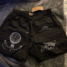 I Bought This One By Accident. Never Worn Still Has Tags. Exclusive Shorts. Black Shorts With Pockets For Summer, Urban Summer Bottoms With Elastic Waistband, Beach Cotton Bottoms With Graphic Print, Beach Graphic Print Cotton Bottoms, Graphic Print Cotton Beach Bottoms, Black Shorts With Side Pockets For Spring, Black Bottoms With Letter Print For Spring, Summer Streetwear Bottoms With Letter Print, Black Bottoms With Letter Print