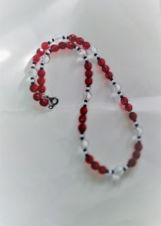 Garnet colour red beads glass contrasted with  clear glass beads, and opaque black and white  beads. Hand made item. Red Beaded Necklaces, Garnet Red, Clear Beads, Crystal Bead Necklace, Strung Beads, Red Beads, Necklace Red, Bead Stringing, Red Bead