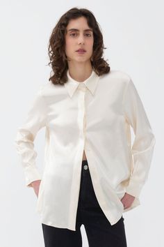 An easy and casual shirt for everyday wear, this collared shirt with long sleeves, cuffs, and a front button closure is a timeless addition to your wardrobe, adding just the right amount of character. Dry clean Material: 76% Rayon 22% Viscose 2% Elastane Long sleeves with cuffs Officially licensed Imported Brand: Nocturne Model Product Size: S Model Size: Height 5'10 / Bust 29.5 in / Waist 23 in / Hips 34 in True the size Long Sleeve Satin Shirt With Button Closure, Led Fashion, Fragrance Design, Beauty Trends, S Models, Travel Size Products, Top Shirt, Casual Shirts, Everyday Wear