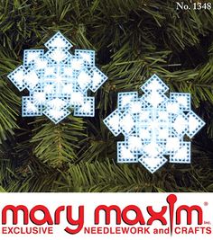 two snowflakes are hanging from a christmas tree with the words mary moxm