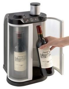 a person is opening a wine bottle in a cooler