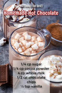 hot chocolate with marshmallows and whipped cream in two mugs next to each other