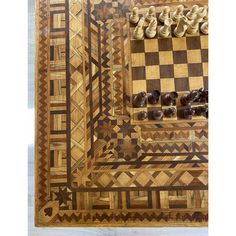 a wooden chess board with several pieces on it