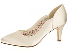 a woman's white high heeled shoe with flowers on the toe and heels