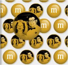 a group of people are surrounded by balls with the letter m on them in black and yellow