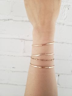 * This elegant bracelet has a bit of a playful attitude. Hand formed into a gentle wave shape and hammered for a faceted texture that reflects the light beautifully! * Lightweight and comfortable, with an easy to use latch clasp. * Made from top quality 14K gold fill (rolled gold) so it won't tarnish or turn like plated materials. Wear 24/7. Excellent for sensitive skin! * Lead and nickel free. * Comes packaged in a gift box. * When ordering- choose the length that matches the actual measurement Everyday Hammered Bangle Bracelets, Everyday Hammered Bangle Bracelet, Dainty Rose Gold Bangle Bracelet, Dainty Rose Gold 14k Gold Bangle, Minimalist Hammered Gold Bracelets, Minimalist Rose Gold Bangle Chain Bracelet, Everyday 14k Rose Gold Bangle, Minimalist Rose Gold Bangle Bracelet, Dainty Rose Gold Everyday Bangle