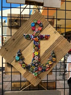 an anchor made out of bottle caps is on display