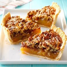 four pieces of pecan pie on a white plate