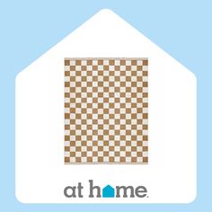 a brown and white checkered area rug with the words at home written below it