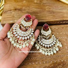 Tayani Kundan gold plated Carved Ruby Dangling chandbali earrings.  Size : 4 inches approx Bollywood Style Kundan Hoop Earrings With Intricate Design, Kundan Hoop Earrings With Intricate Design For Diwali, Intricate Kundan Hoop Earrings For Diwali, Eid Kundan Chandbalis With Intricate Design, Eid Chandbalis With Intricate Kundan Design, Eid Chandbalis With Intricate Design In Kundan, Chandbali Danglers For Celebration, Heavy Chandbali Chandbalis For Celebration, Bridal Kundan Chandbali Earrings With Meenakari