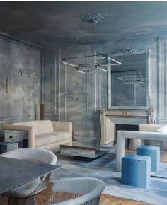 a living room filled with white furniture and walls painted in shades of blue, grey and white