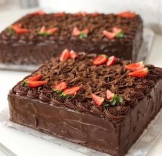 two slices of chocolate cake with strawberries on top