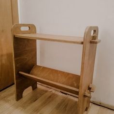 a wooden bench sitting on top of a hard wood floor next to a door in a room