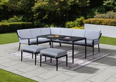 an outdoor patio furniture set with grey cushions and matching table, bench and stools