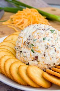 a plate with crackers and cheese ball on it